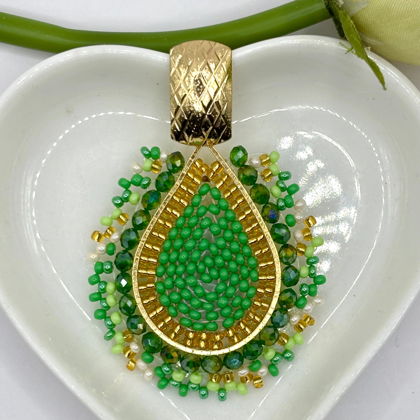 Close-up of handcrafted Cayena Earrings, inspired by the hibiscus flower, featuring intricate floral details in vibrant colors, perfect for tropical and summer fashion.