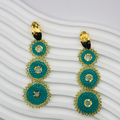 A pair of gold-plated Nala Earrings with intricate detailing, displayed elegantly against a soft velvet background, capturing their luxurious and timeless appeal.