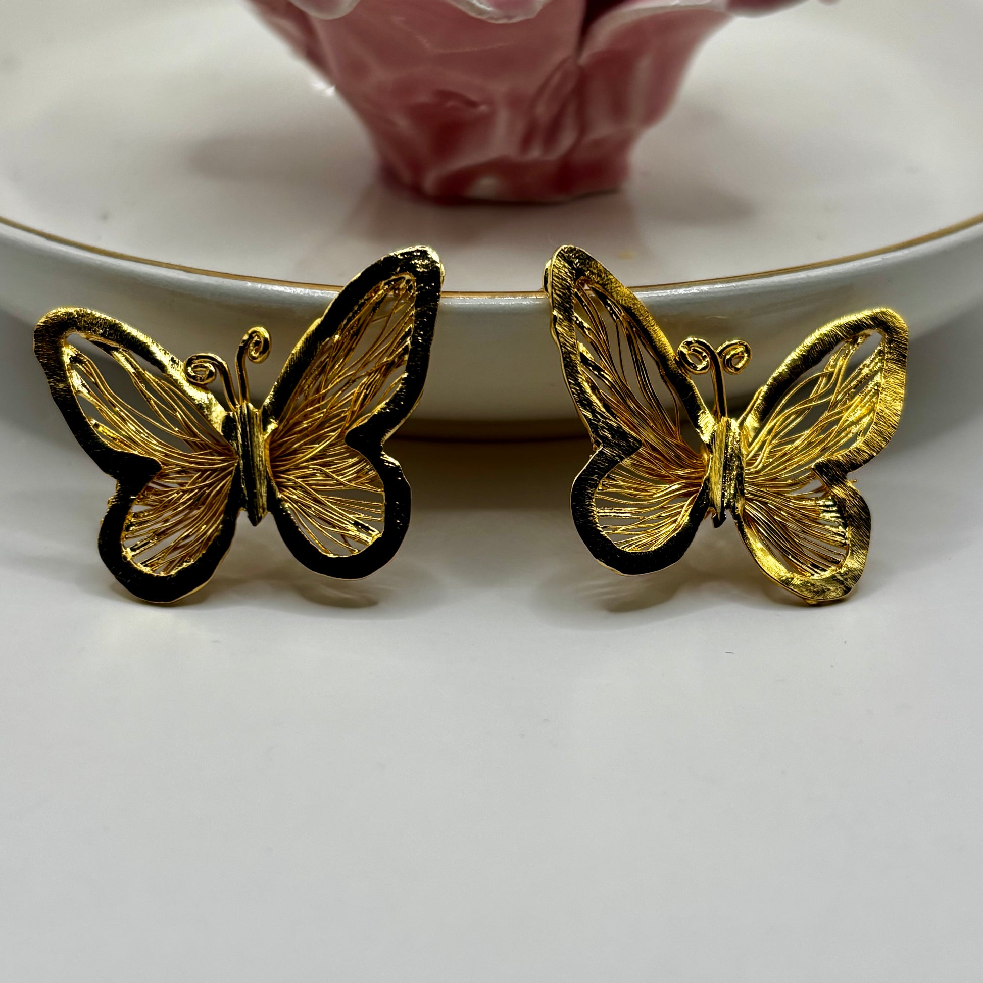 “Elegant butterfly-shaped earrings with delicate design, adding sophistication and charm to any outfit.”