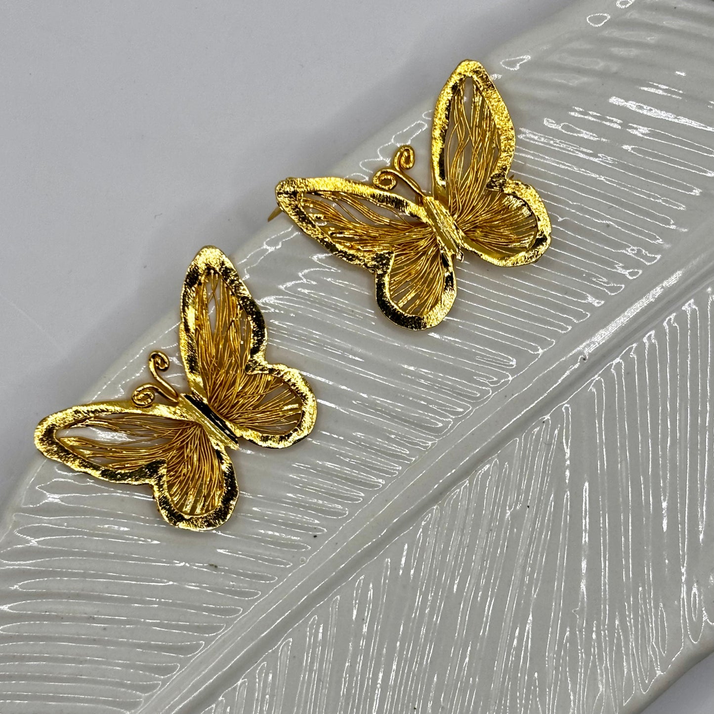 Elegant butterfly-shaped earrings with delicate design, adding sophistication and charm to any outfit.