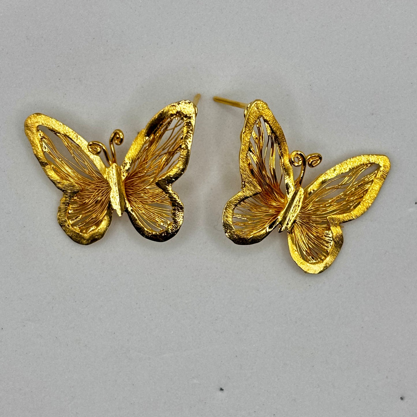 Elegant butterfly-shaped earrings with delicate design, adding sophistication and charm to any outfit.