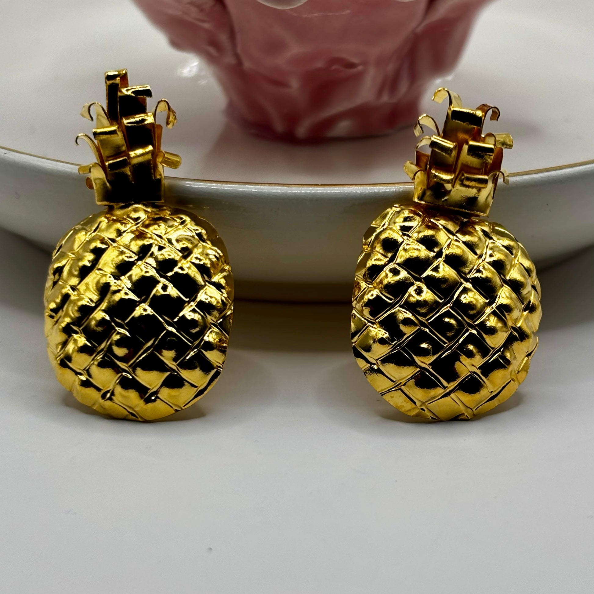 Elegant pineapple-shaped earrings with a playful design, adding a chic and tropical touch to any outfit.