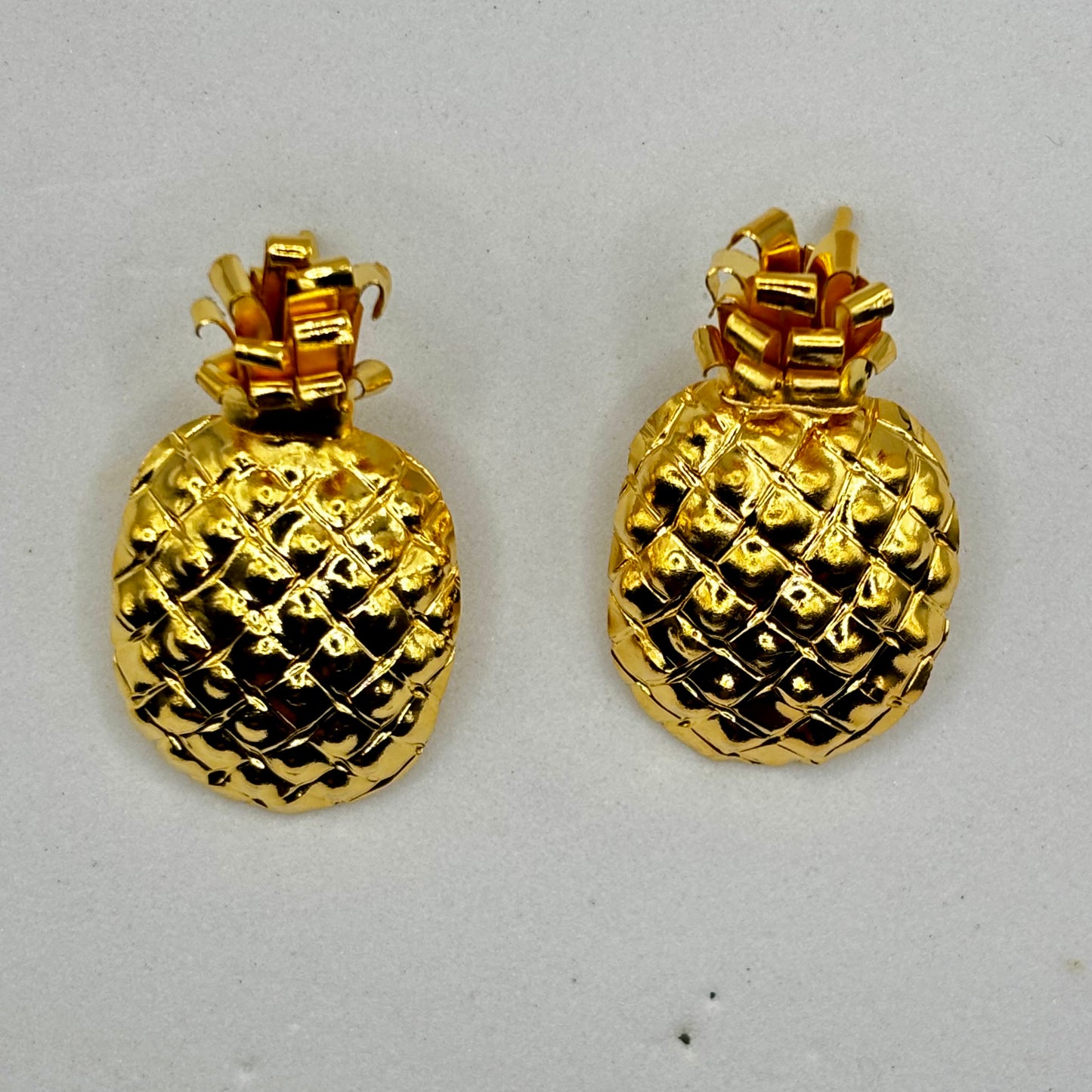 Elegant pineapple-shaped earrings with a playful design, adding a chic and tropical touch to any outfit.