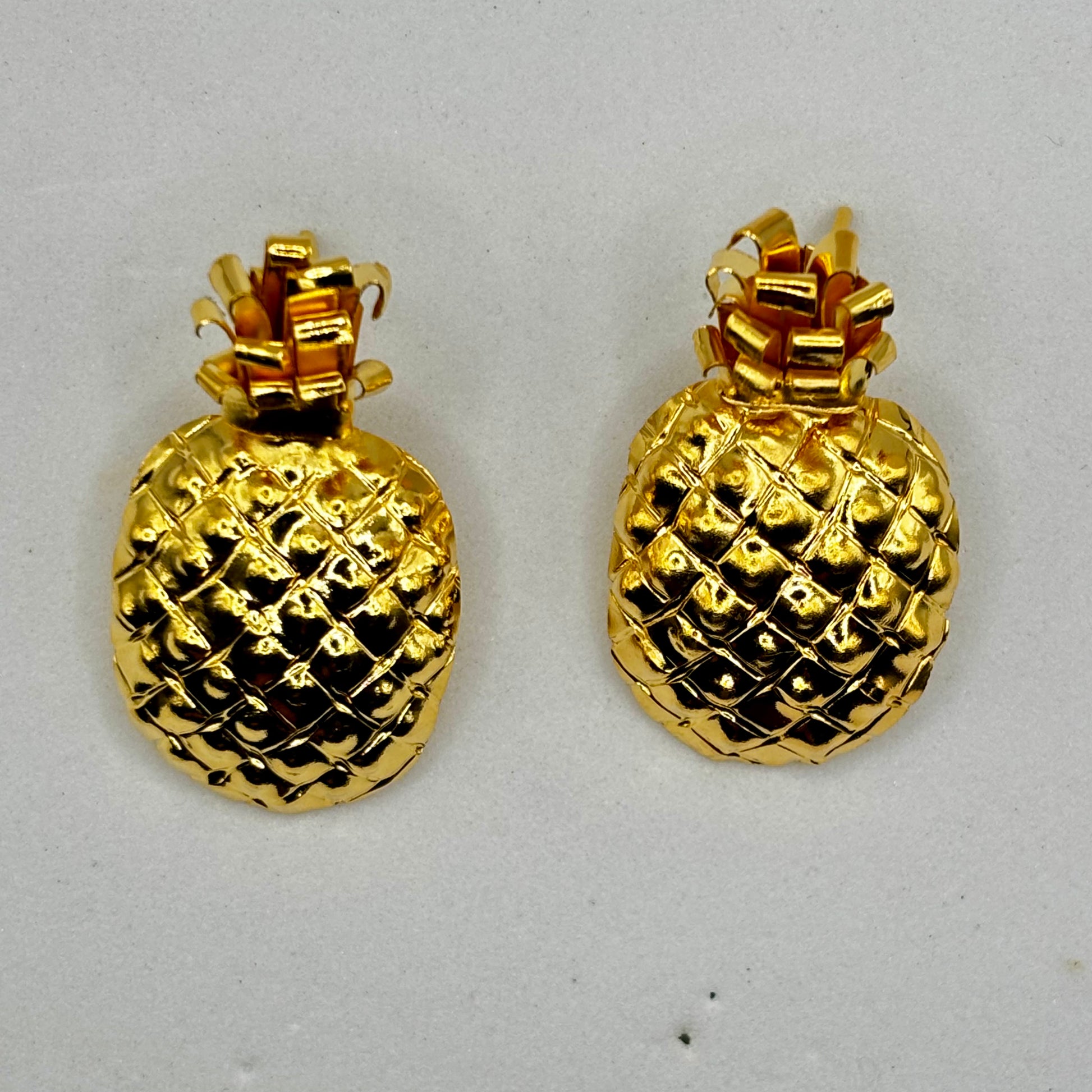 Elegant pineapple-shaped earrings with a playful design, adding a chic and tropical touch to any outfit.