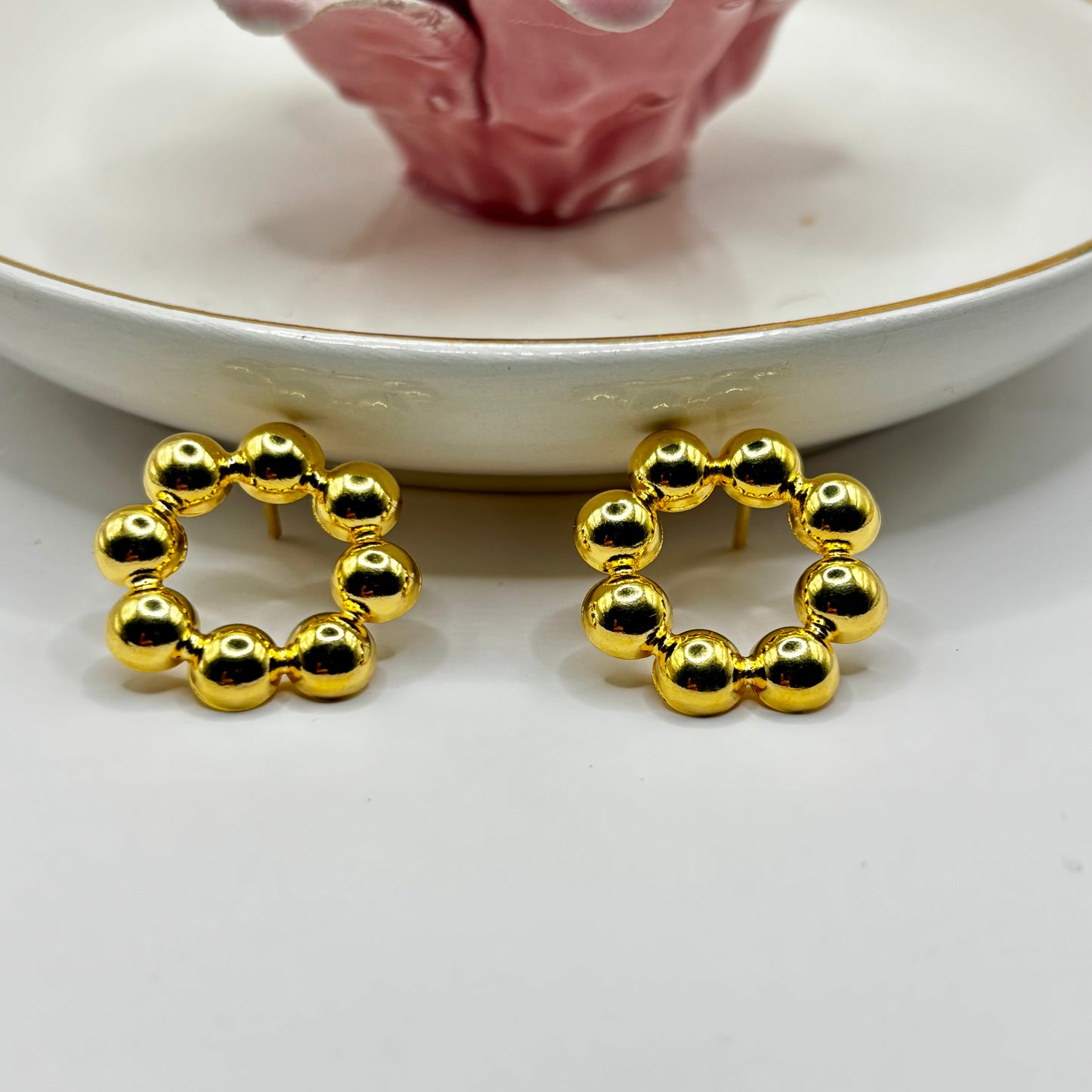 Elegant bead-shaped earrings with a sophisticated design, adding a timeless and refined touch to any ensemble.