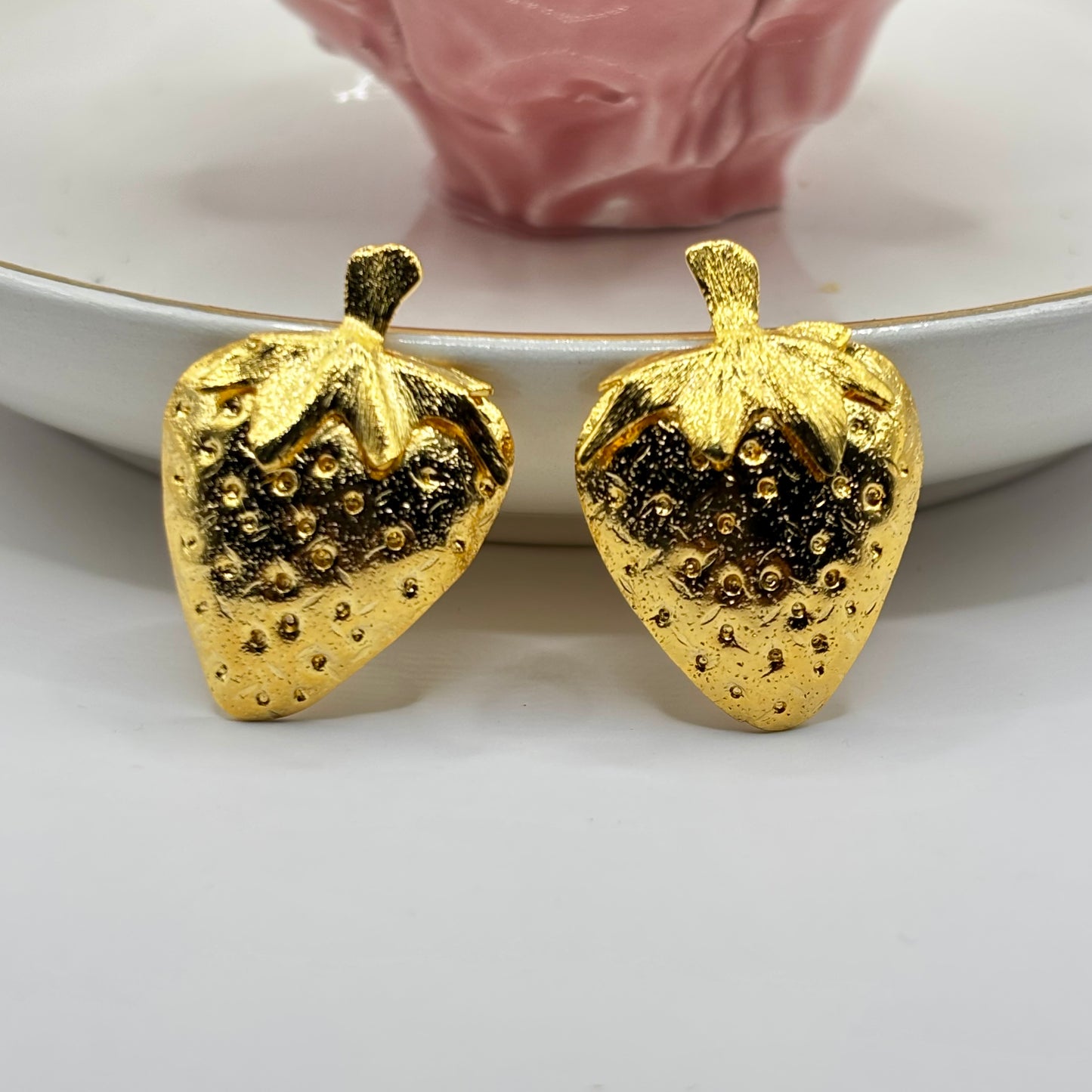 Strawberry-shaped earrings with a playful design, adding a fun and nature-inspired touch to any outfit