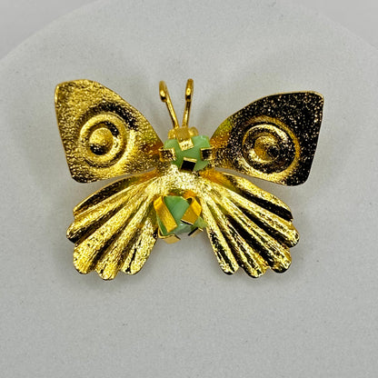 Close-up of an elegant butterfly fancy pin brooch with intricate details and shimmering gemstone accents