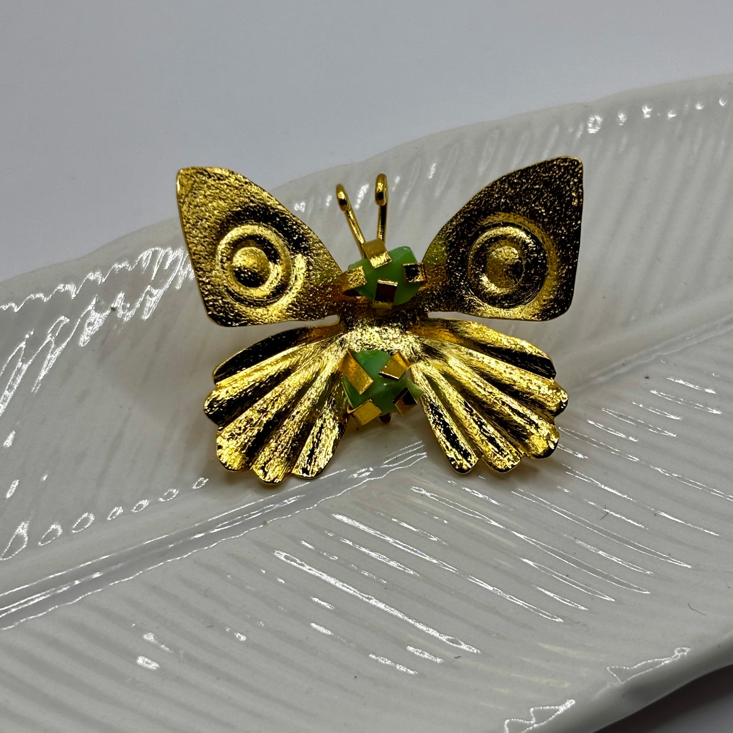 Close-up of an elegant butterfly fancy pin brooch with intricate details and shimmering gemstone accents