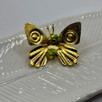 Close-up of an elegant butterfly fancy pin brooch with intricate details and shimmering gemstone accents