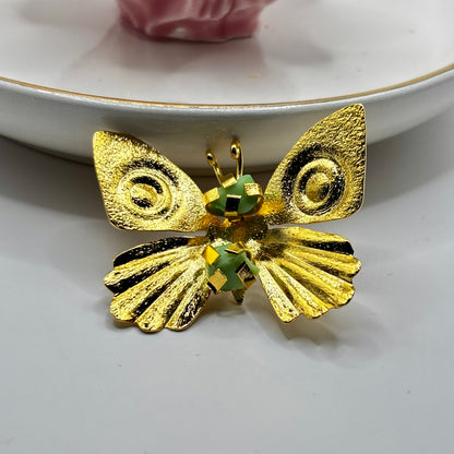 Close-up of an elegant butterfly fancy pin brooch with intricate details and shimmering gemstone accents