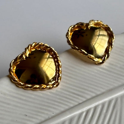 Gold heart-shaped hoop earrings with a smooth, polished finish