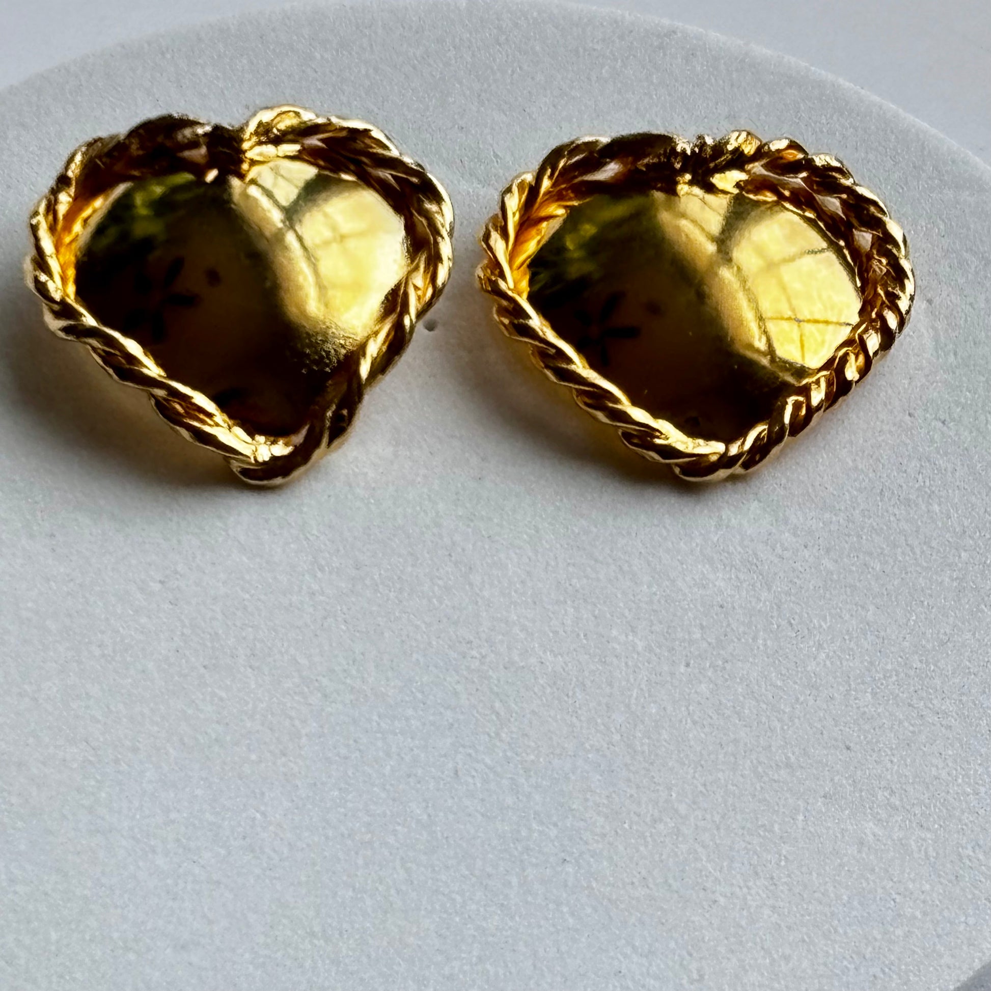 Gold heart-shaped hoop earrings with a smooth, polished finish