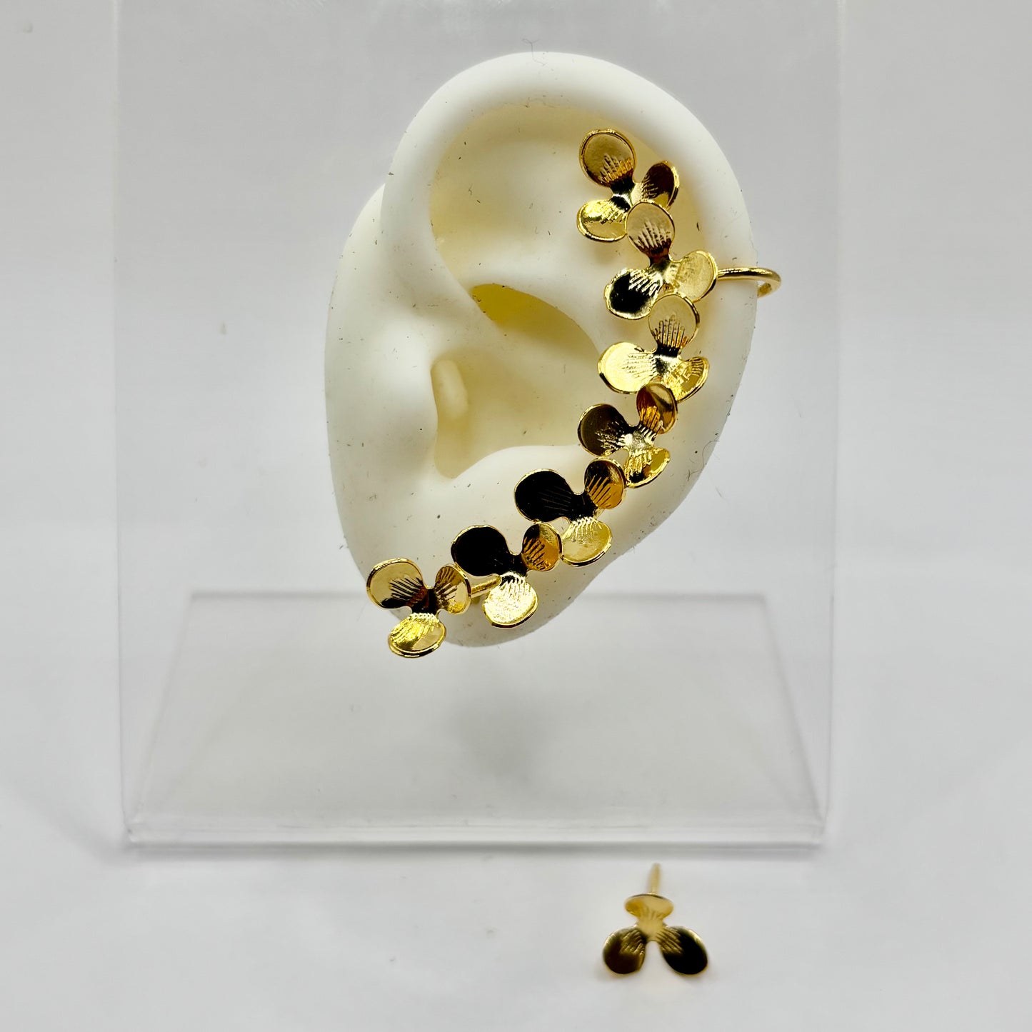 Gold T3 Petals Ear Wrap featuring three sleek floral clusters, designed for a comfortable and elegant fit without piercings