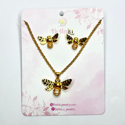 Gold bee necklace and earrings set on a Bella Lu branded card with floral design.