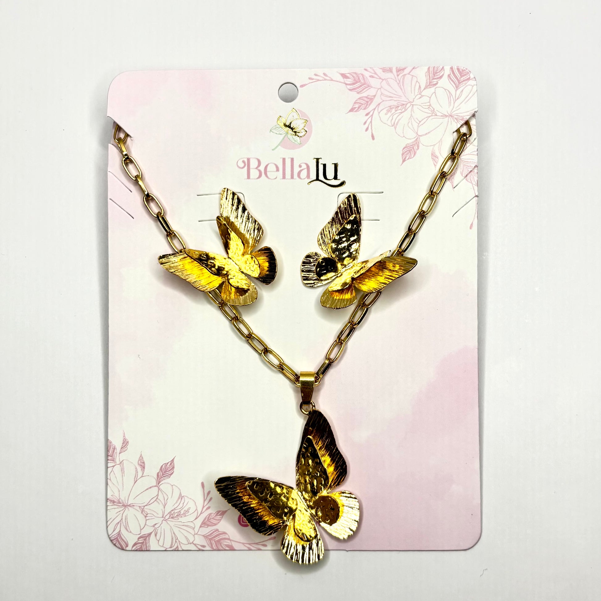 Butterfly necklace on a Bella Lu branded card with a floral design