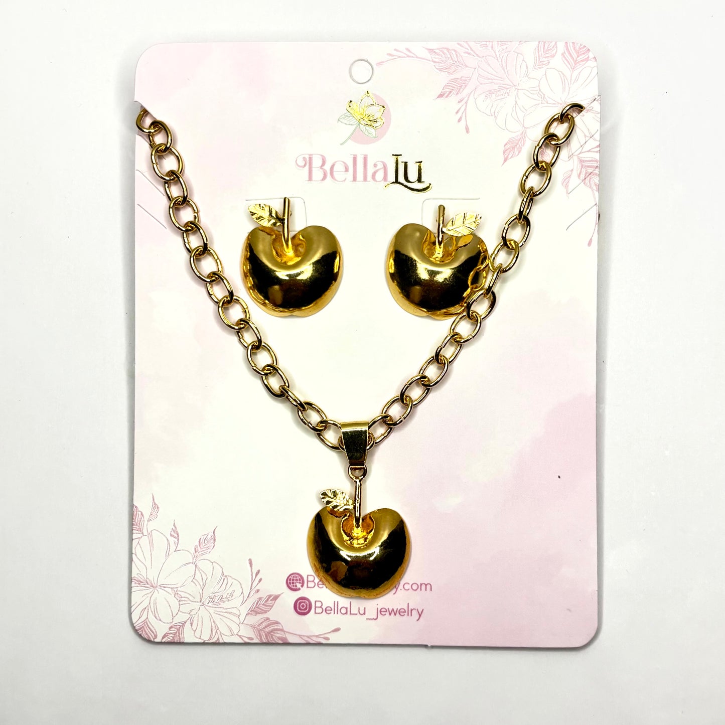 Gold heart necklace and earrings apple set on a Bella Lu branded card.