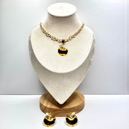 Gold necklace and earrings apple on a mannequin bust with a white background