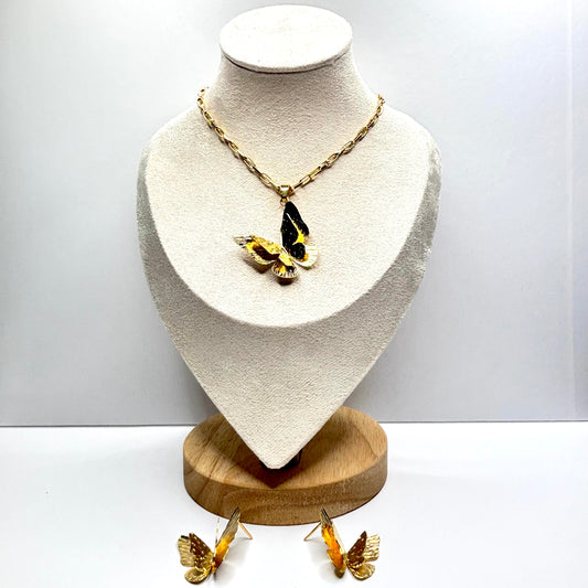 Butterfly-themed necklace and earrings on a mannequin bust with a white background