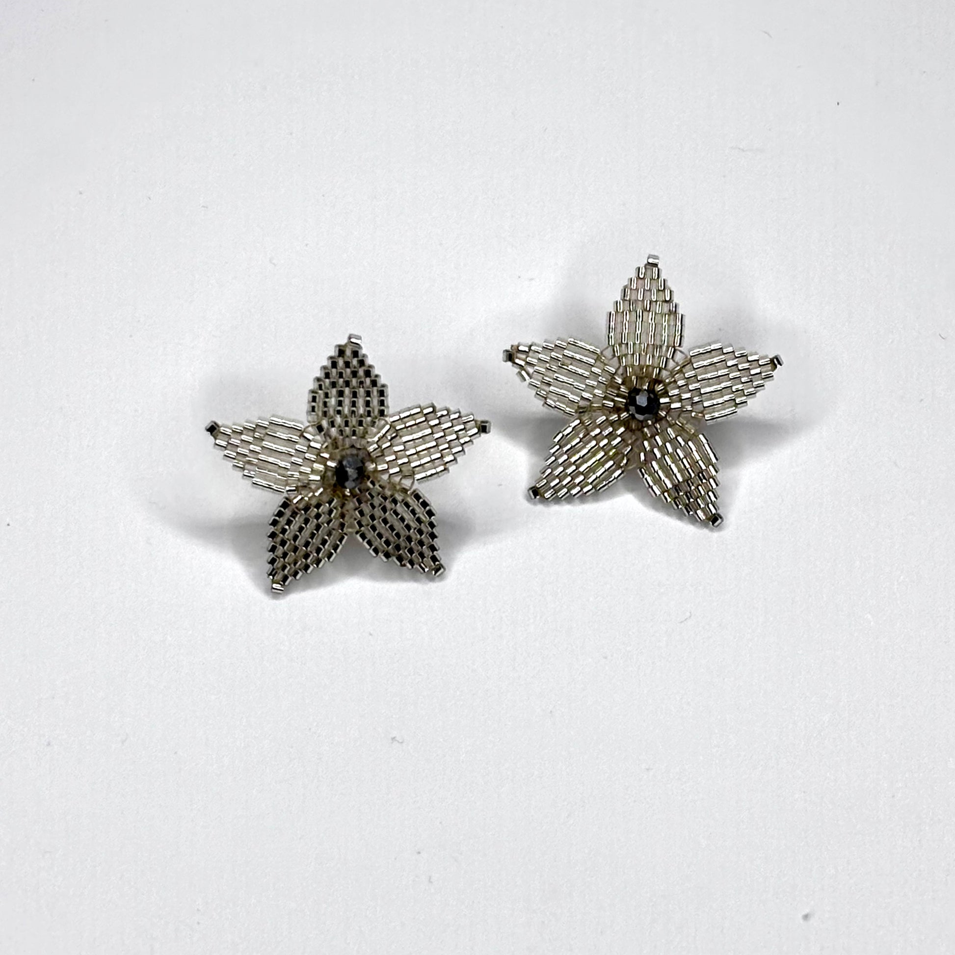 Pair of star-shaped earrings on a white background