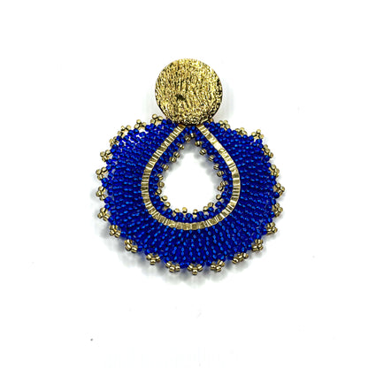 Blue beaded earring with gold accents on a white background