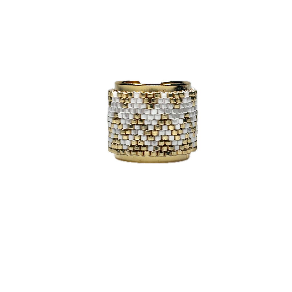 Gold and silver beaded ring on a white background