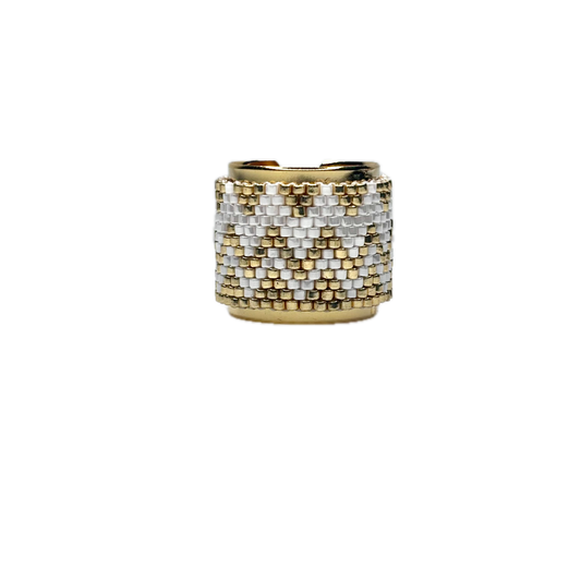 Gold and silver beaded ring on a white background