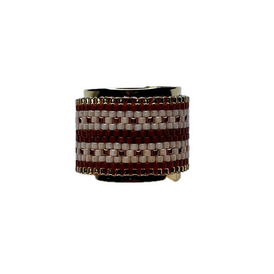 Ring with brown and white woven pattern on a white background