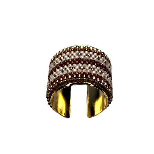 Wide gold ring with a textured band on a white background