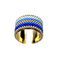 Gold ring with blue and white striped design on a black background