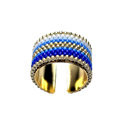 Gold ring with blue and white striped design on a black background