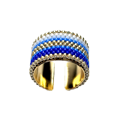 Gold ring with blue and white striped design on a black background
