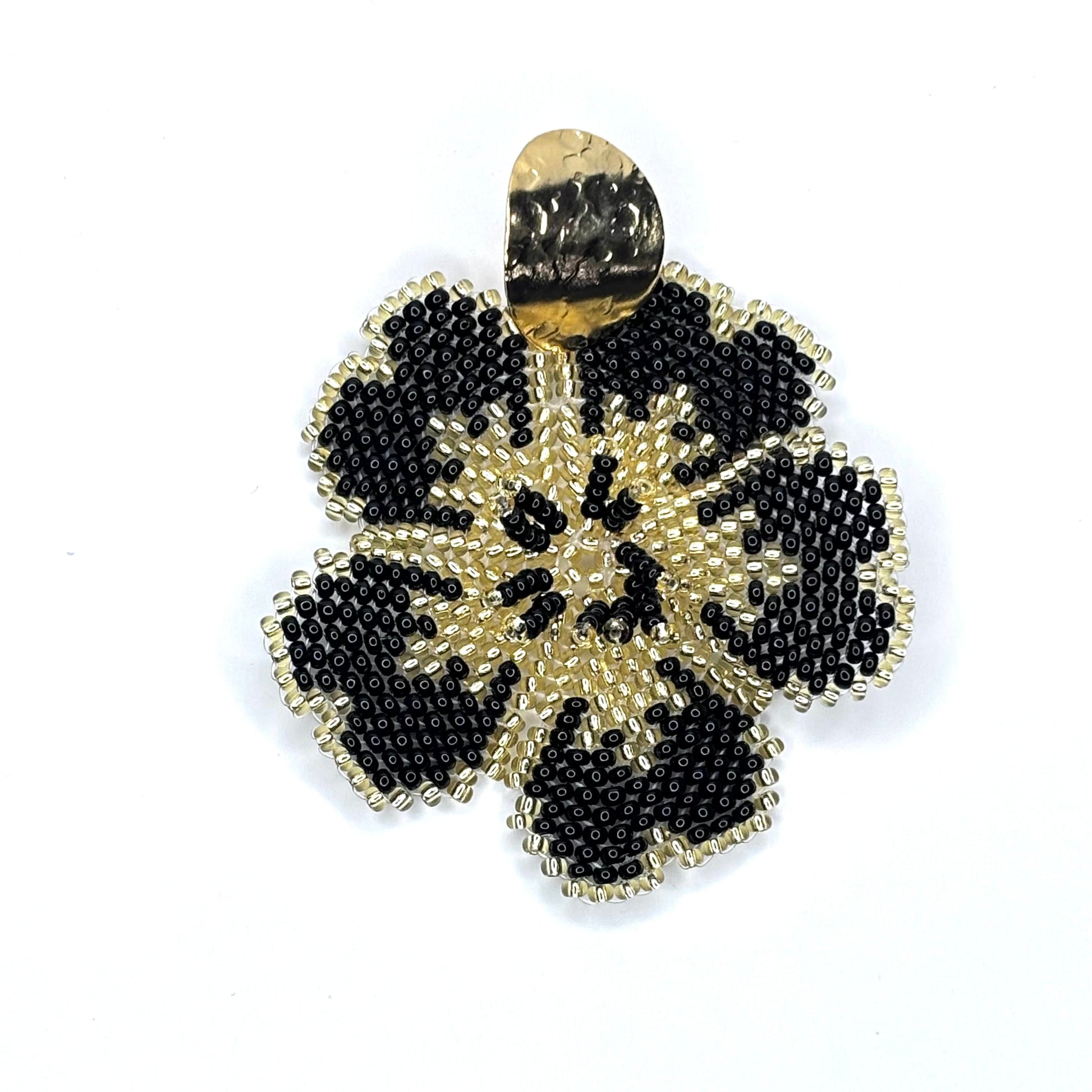 Gold and black beaded flower-shaped earring on a white background