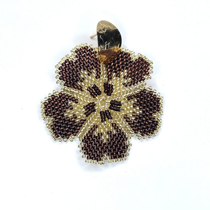 Beaded flower-shaped earring brown on a white background