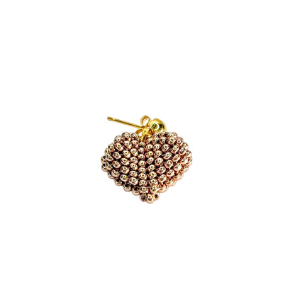 Gold beaded heart-shaped earring on a white background