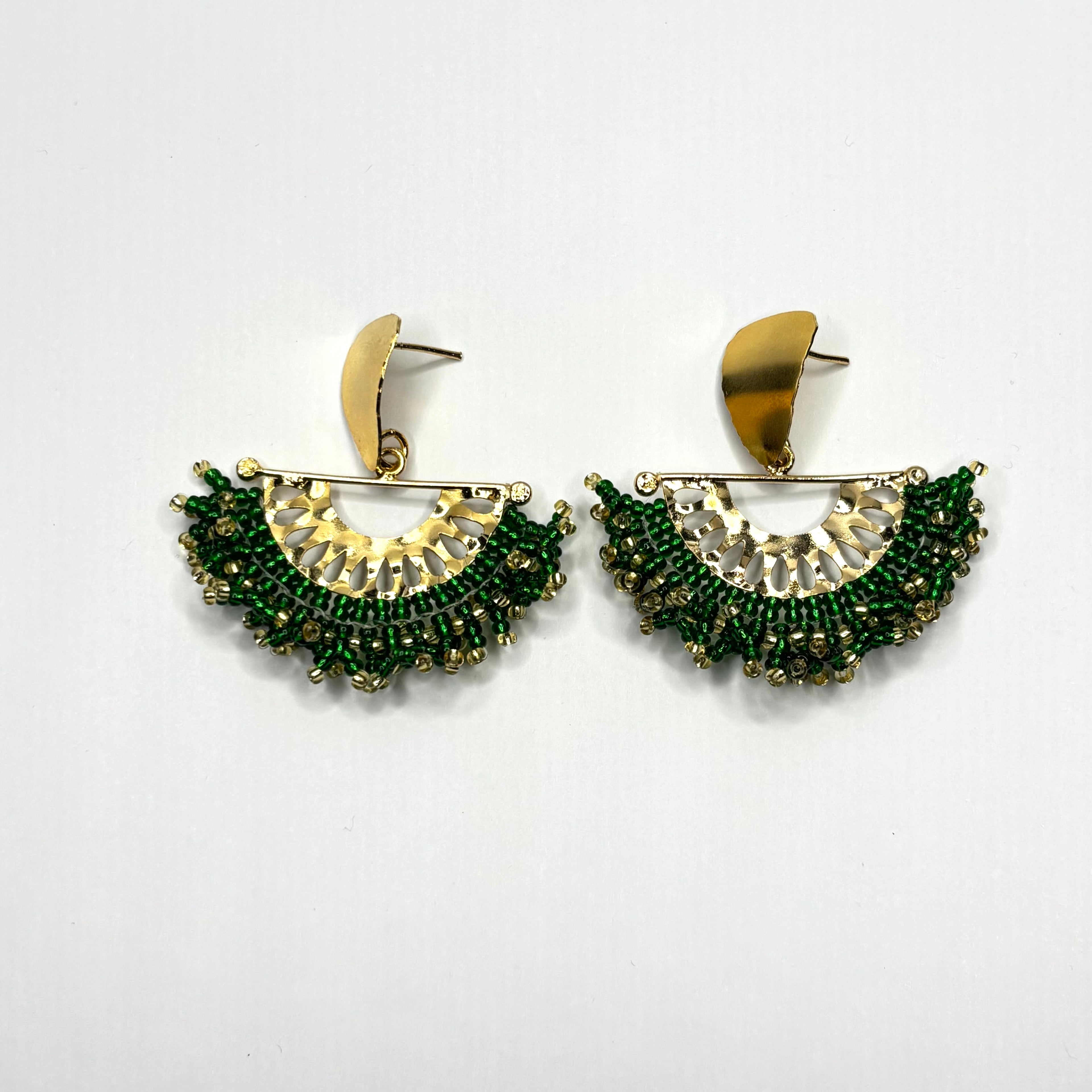 Pair of gold and green earrings on a white background