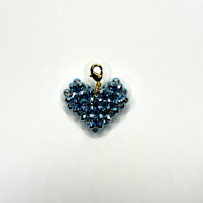 Heart-shaped blue beaded pendant on a white background