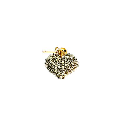 Gold heart-shaped earring on a white background