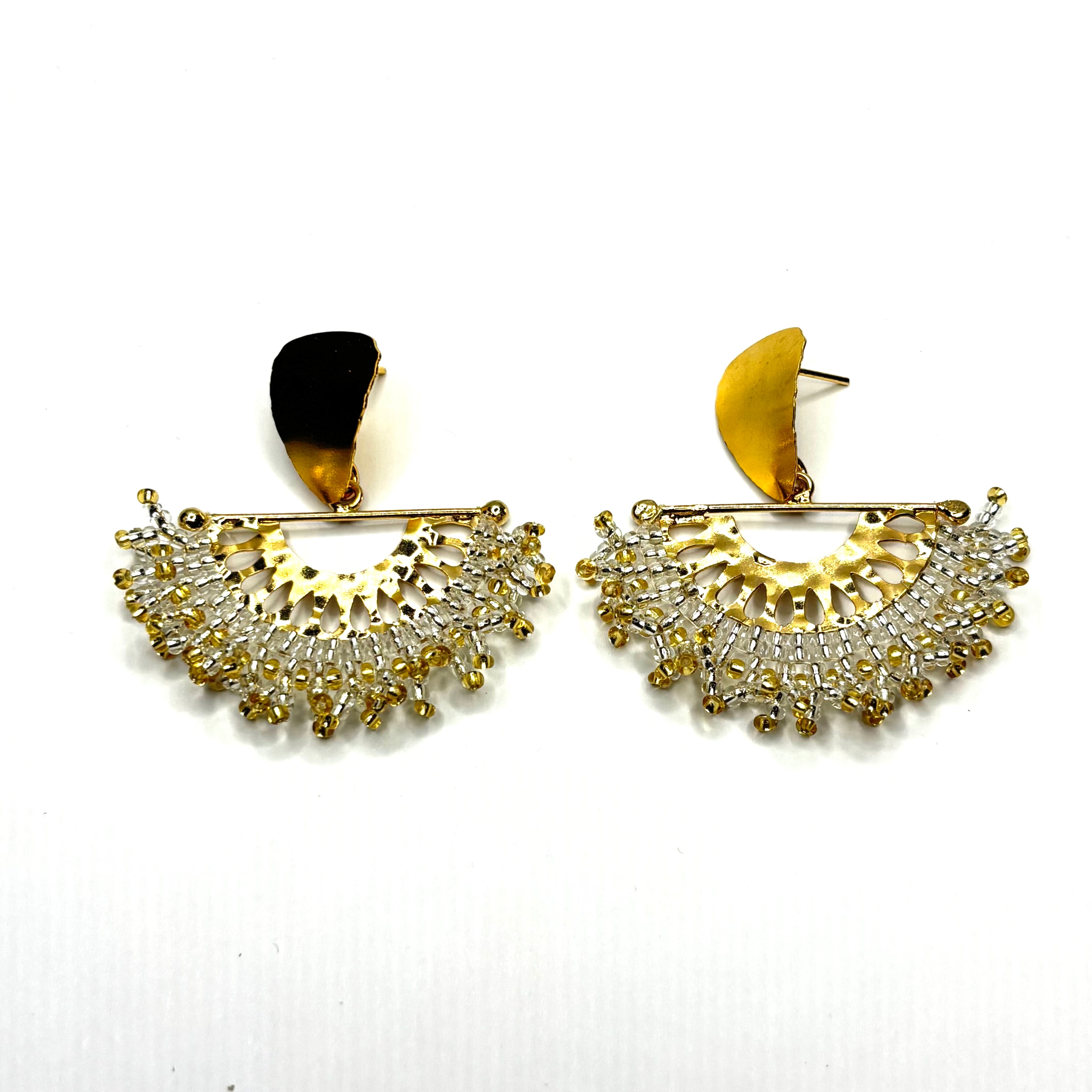 Gold and diamond earrings on a white background