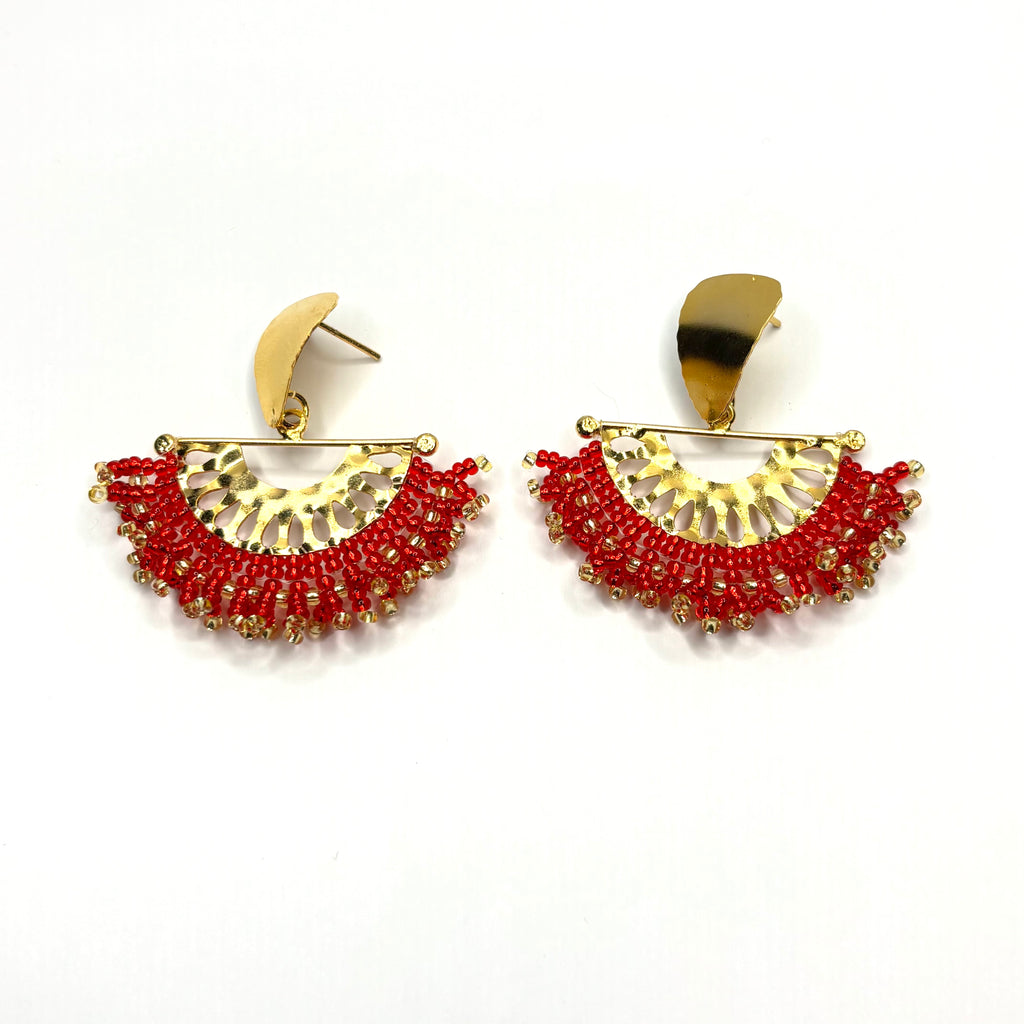 Pair of gold and red earrings on a white background