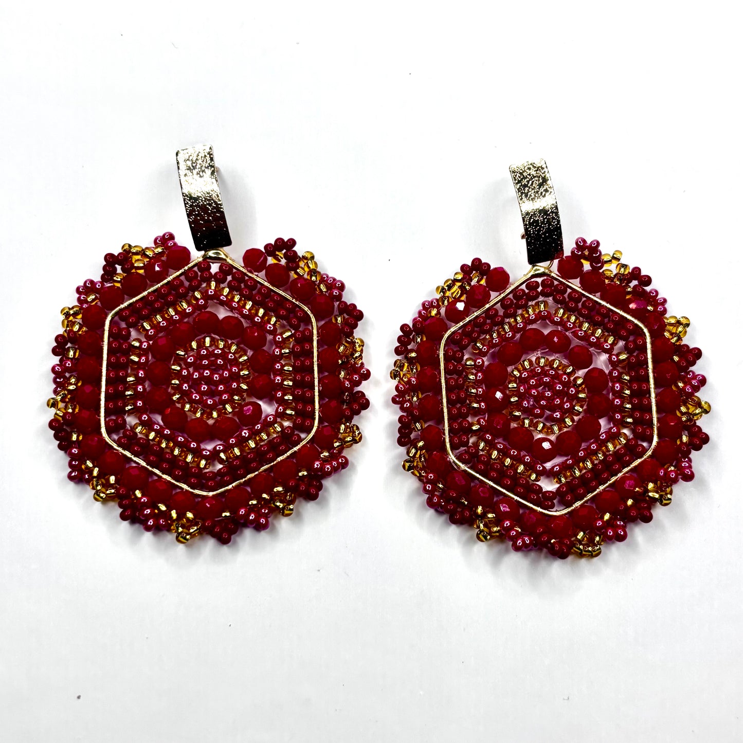Pair of red beaded earrings on a white background