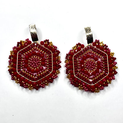 Pair of red beaded earrings on a white background