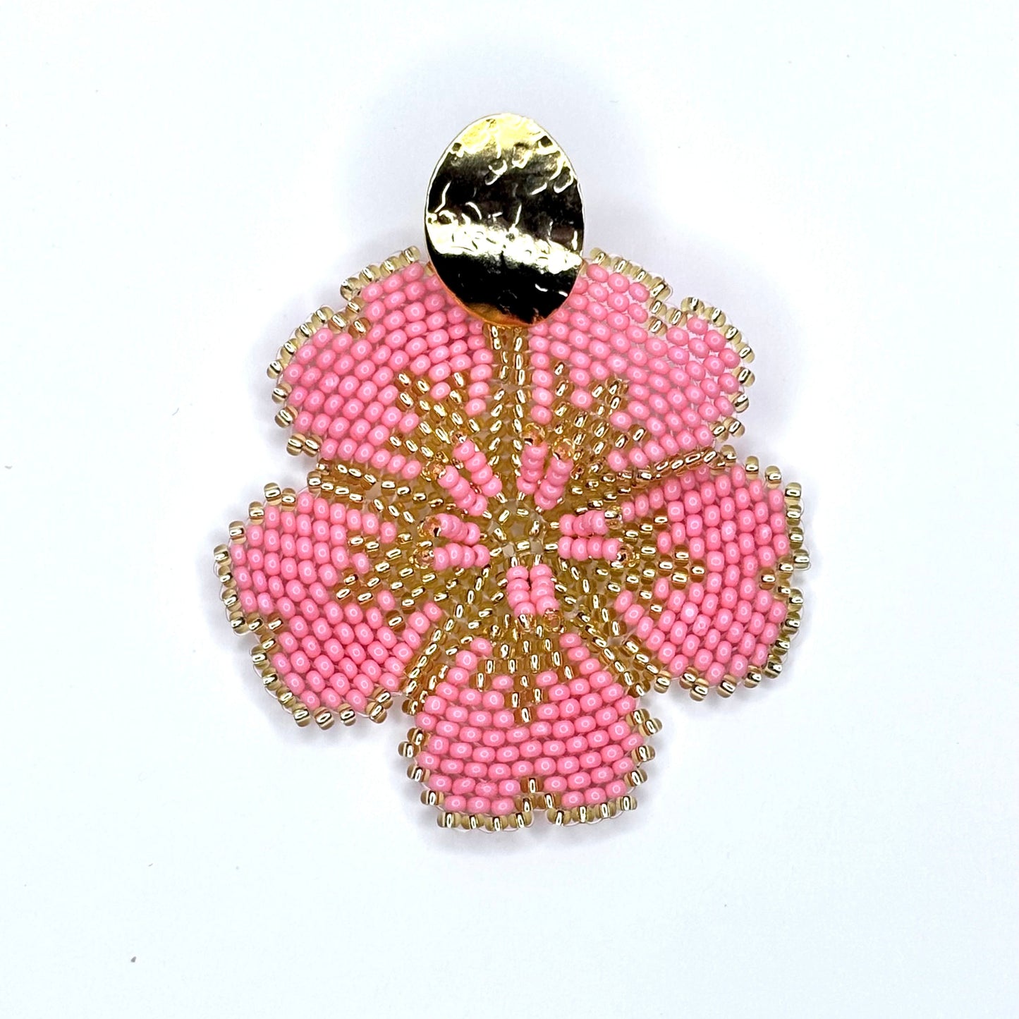 Salmon beaded earring with gold accents on a white background