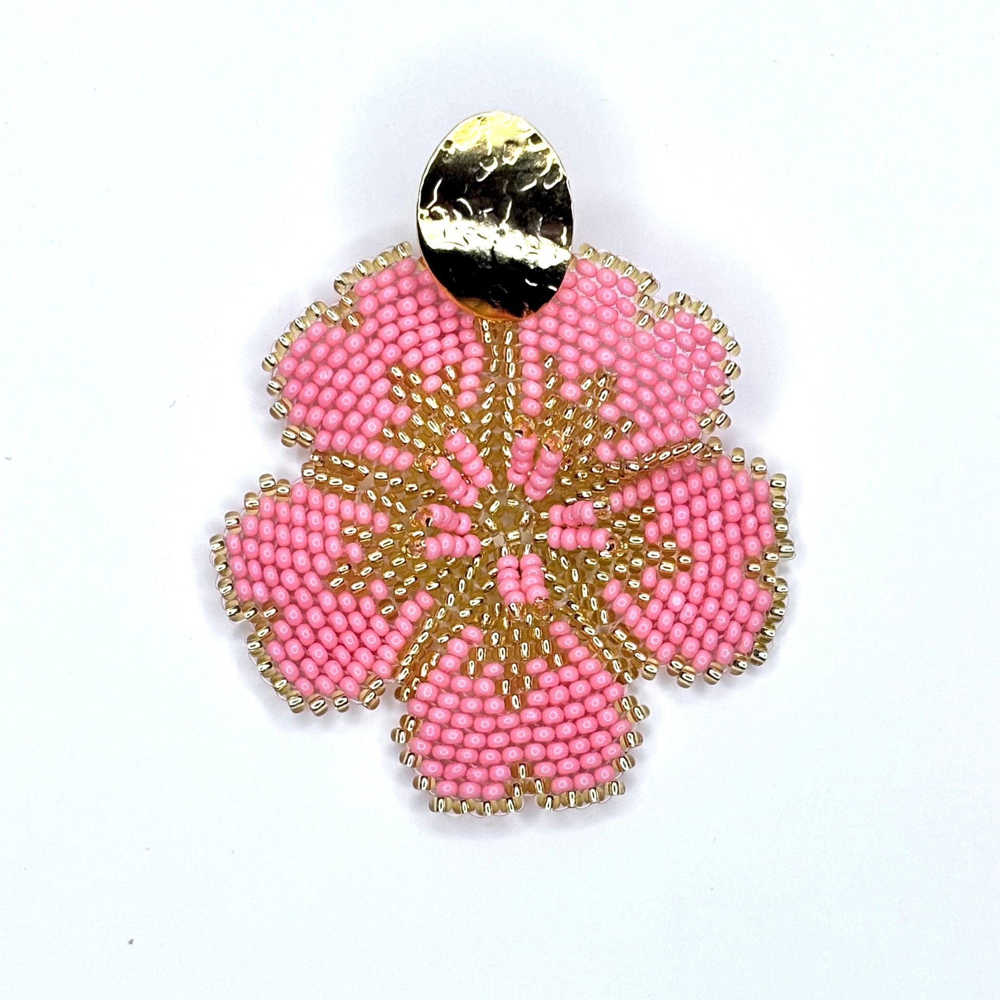 Salmon beaded earring with gold accents on a white background